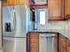 Kitchen featuring stainless steel appliances, granite countertops, and wood cabinets at 1605 Manor Rd, Englewood, FL 34223