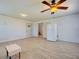 Bright living room with tile floors, a ceiling fan, and a refrigerator near the entryway at 1605 Manor Rd, Englewood, FL 34223