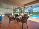 Screened in patio with seating area and view of the water and pool at 1605 Manor Rd, Englewood, FL 34223