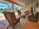 Spacious screened patio featuring tile flooring and comfortable seating for relaxation at 1605 Manor Rd, Englewood, FL 34223