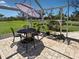 Relaxing patio with outdoor dining set and lush landscaping, perfect for outdoor enjoyment at 1605 Manor Rd, Englewood, FL 34223