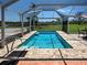 Sparkling pool area featuring a screened enclosure, brick paving, and a pristine setting at 1605 Manor Rd, Englewood, FL 34223