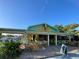 Charming restaurant exterior with vibrant decor, outdoor seating, and lush landscaping at 1605 Manor Rd, Englewood, FL 34223