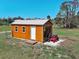Well-maintained shed with a lawn mower inside, providing ample storage space at 1605 Manor Rd, Englewood, FL 34223