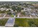 Aerial view of the property, showing the house with its surrounding trees and neighborhood at 1664 Karluk St, North Port, FL 34287