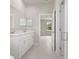 Hallway bathroom featuring double vanity and marble tile at 1664 Karluk St, North Port, FL 34287