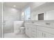 Bright bathroom featuring double vanity, a glass-enclosed shower, and marble tile at 1664 Karluk St, North Port, FL 34287