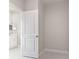 Bright bathroom entry featuring tile flooring and modern white cabinets and a mirror at 1664 Karluk St, North Port, FL 34287