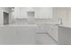 Bright kitchen featuring white cabinets, quartz countertops, and a kitchen island at 1664 Karluk St, North Port, FL 34287