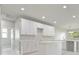 Bright kitchen featuring white cabinets, quartz countertops, and recessed lighting at 1664 Karluk St, North Port, FL 34287