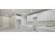 Modern kitchen boasts white cabinets, quartz countertops, and stainless steel appliances at 1664 Karluk St, North Port, FL 34287