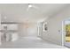 Open floor plan connecting the living room and kitchen with white tile flooring at 1664 Karluk St, North Port, FL 34287