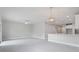 Large, open living room with modern light fixtures and access to the kitchen at 1664 Karluk St, North Port, FL 34287