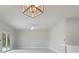 Spacious living room with modern lighting and sliding glass doors to the outside at 1664 Karluk St, North Port, FL 34287