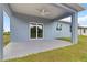 Relax under the covered patio featuring a ceiling fan and a sliding door entry to the home at 1664 Karluk St, North Port, FL 34287