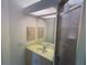 Bathroom featuring a vanity with double drawers, shower with glass door, and a large mirror at 169 Boundary Blvd # 169P, Rotonda West, FL 33947