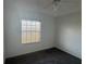 Bedroom with carpet flooring, a ceiling fan, and natural light from a single window at 169 Boundary Blvd # 169P, Rotonda West, FL 33947
