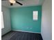 Bedroom featuring a teal accent wall, plush carpet, and natural lighting at 169 Boundary Blvd # 169P, Rotonda West, FL 33947