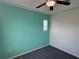 Bedroom featuring light green accent wall with window and carpeting at 169 Boundary Blvd # 169P, Rotonda West, FL 33947