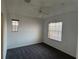 Bedroom with neutral carpet, ceiling fan, and windows for natural light at 169 Boundary Blvd # 169P, Rotonda West, FL 33947