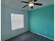 Bedroom with teal accent wall, plush carpet, and natural lighting at 169 Boundary Blvd # 169P, Rotonda West, FL 33947