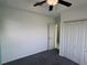 Bright bedroom featuring a ceiling fan, closet, and neutral gray carpeting at 169 Boundary Blvd # 169P, Rotonda West, FL 33947
