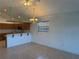 View of dining room with a partial view of kitchen, light fixtures and a window with wood blinds at 169 Boundary Blvd # 169P, Rotonda West, FL 33947