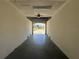Inside empty garage looking out towards the neighborhood at 169 Boundary Blvd # 169P, Rotonda West, FL 33947