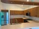 Kitchen with wood cabinets and stainless steel appliances at 169 Boundary Blvd # 169P, Rotonda West, FL 33947