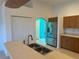 A stainless steel refrigerator stands prominently in the kitchen, with white double doors and warm wood cabinets at 169 Boundary Blvd # 169P, Rotonda West, FL 33947