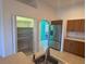 Kitchen with stainless steel appliances and pantry; tile floors, sink, and archway to adjacent rooms at 169 Boundary Blvd # 169P, Rotonda West, FL 33947