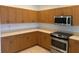 Spacious kitchen showcasing wood cabinets, stainless steel appliances, and ample countertop space at 169 Boundary Blvd # 169P, Rotonda West, FL 33947