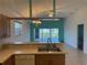 Kitchen with island overlooking large living room and screened patio at 169 Boundary Blvd # 169P, Rotonda West, FL 33947