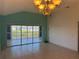 Vaulted living room with tile flooring and access to a screened patio overlooking the water at 169 Boundary Blvd # 169P, Rotonda West, FL 33947