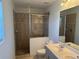 Bathroom featuring double sinks, a shower with glass enclosure and tile walls at 169 Boundary Blvd # 169P, Rotonda West, FL 33947