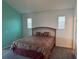 Spacious main bedroom with carpet, two windows and a queen bed at 169 Boundary Blvd # 169P, Rotonda West, FL 33947