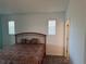 Spacious main bedroom with carpet, two windows and a queen bed at 169 Boundary Blvd # 169P, Rotonda West, FL 33947