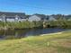 View of pond with blue gray buildings in the background from lanai at 169 Boundary Blvd # 169P, Rotonda West, FL 33947