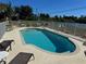 Community pool with lounge chairs and tables on the pool deck, perfect for relaxation at 169 Boundary Blvd # 169P, Rotonda West, FL 33947