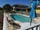 Community pool with tables and chairs surrounded by fencing, an inviting outdoor space at 169 Boundary Blvd # 169P, Rotonda West, FL 33947