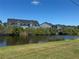 Neighborhood pond view with trees, bushes and multi-story buildings at 169 Boundary Blvd # 169P, Rotonda West, FL 33947