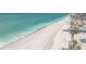 A captivating aerial view of a pristine beachfront, boasting turquoise waters and soft, sandy shores at 1691 Lakeview Pl, Englewood, FL 34223