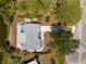 Stunning aerial view of a home with a pool, lush landscaping, and picturesque waterfront at 1691 Lakeview Pl, Englewood, FL 34223
