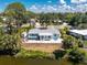 An elevated view shows a well-kept home with a personal outdoor area and hot tub, bordering a relaxing canal at 1691 Lakeview Pl, Englewood, FL 34223