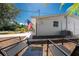 Enjoy the backyard patio with comfortable seating, set against the backdrop of a well-maintained home and American flag at 1691 Lakeview Pl, Englewood, FL 34223