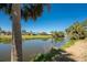 Picturesque backyard view of a canal, tropical landscaping and neighborhood homes at 1691 Lakeview Pl, Englewood, FL 34223