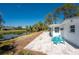 Exterior view featuring a patio with turquoise table set, canal view, and landscaping at 1691 Lakeview Pl, Englewood, FL 34223