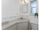 Clean bathroom featuring simple vanity, built in storage, and lots of light at 1691 Lakeview Pl, Englewood, FL 34223
