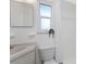 Functional bathroom with built in storage and a bright window at 1691 Lakeview Pl, Englewood, FL 34223