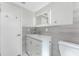 Contemporary bathroom with backlit mirror and updated vanity at 1691 Lakeview Pl, Englewood, FL 34223